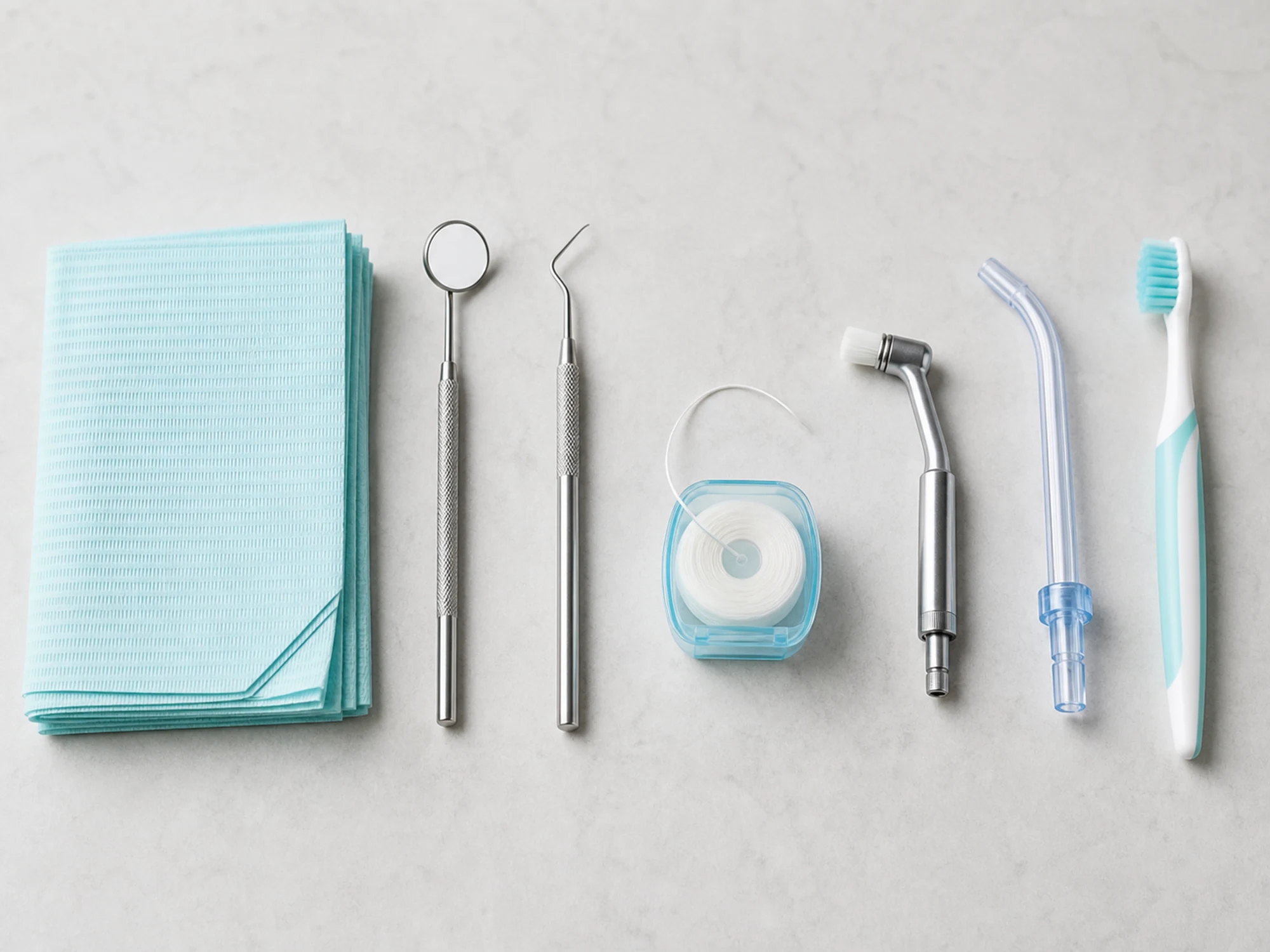 Dental mirror, scaler, floss, polishing cup, and toothbrush arranged in cleaning order