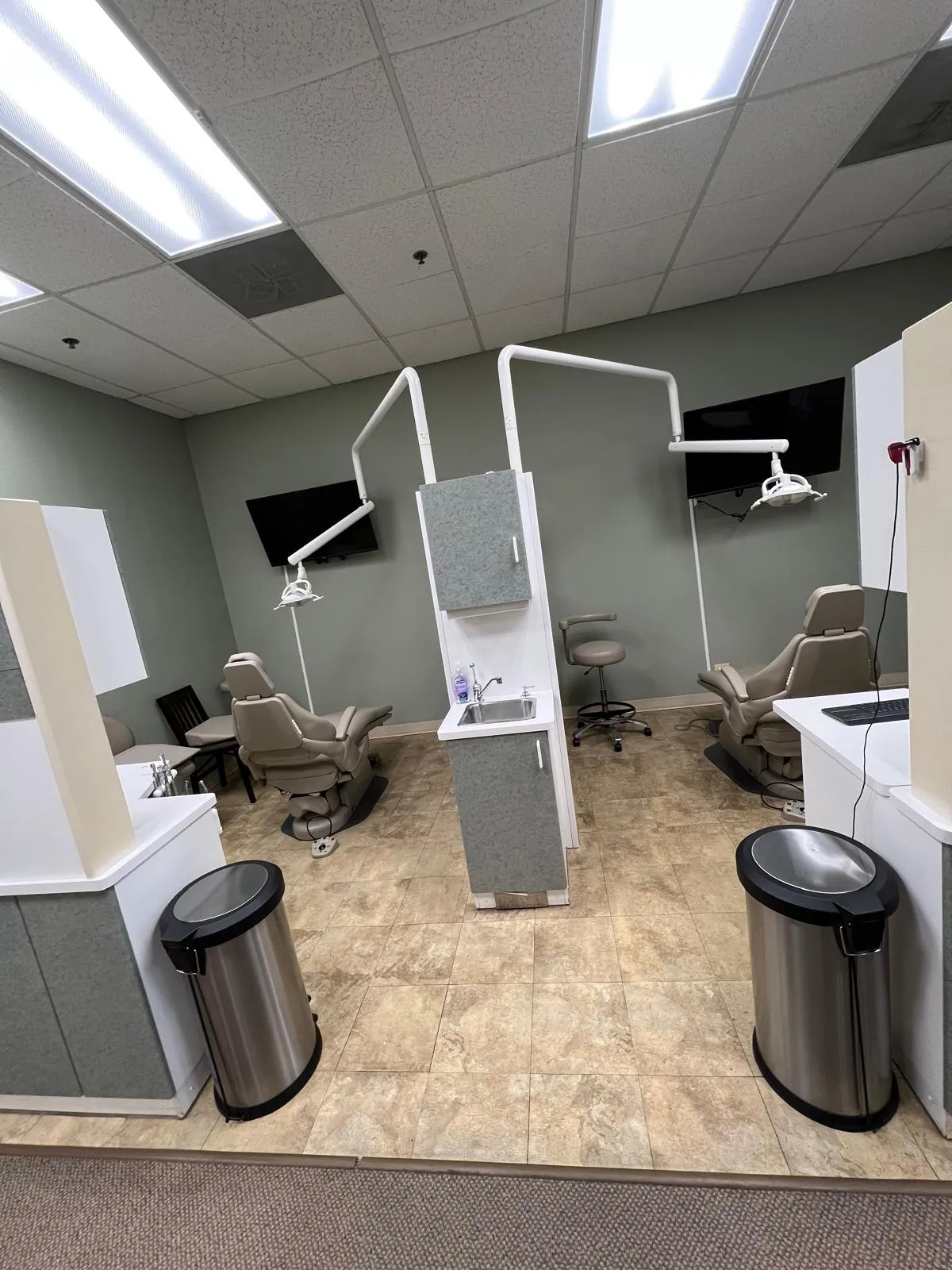 Dental treatment room with patient chairs and exam lights at Urban Dental Care in Woodridge